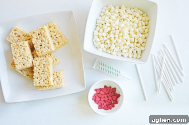 White chocolate chips, red heart sprinkles, and unwrapped Rice Krispies Treats ingredients