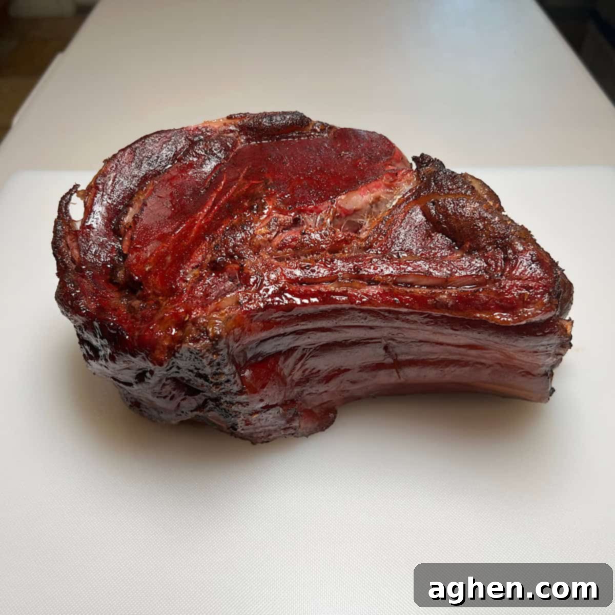 A beautiful, raw prime rib roast, seasoned and ready for the smoker.