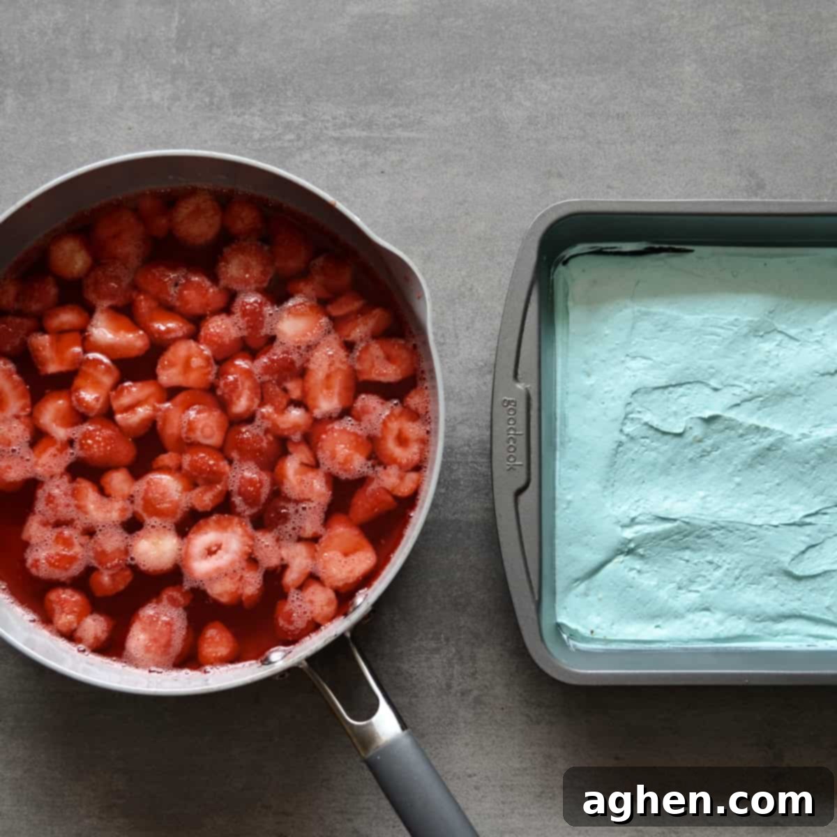 Guilt-Free 2-Point 4th of July Strawberry Pretzel Salad 5 A two-layer dessert in a baking dish, with a blue cheesecake filling base and a liquid red strawberry jello mixture poured over frozen strawberries.