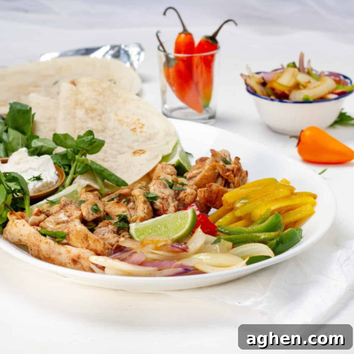 The Best Chicken Fajitas Zero Weight Watchers Points 2 Chicken fajitas with bell pepper and onion on a plate with tortillas.