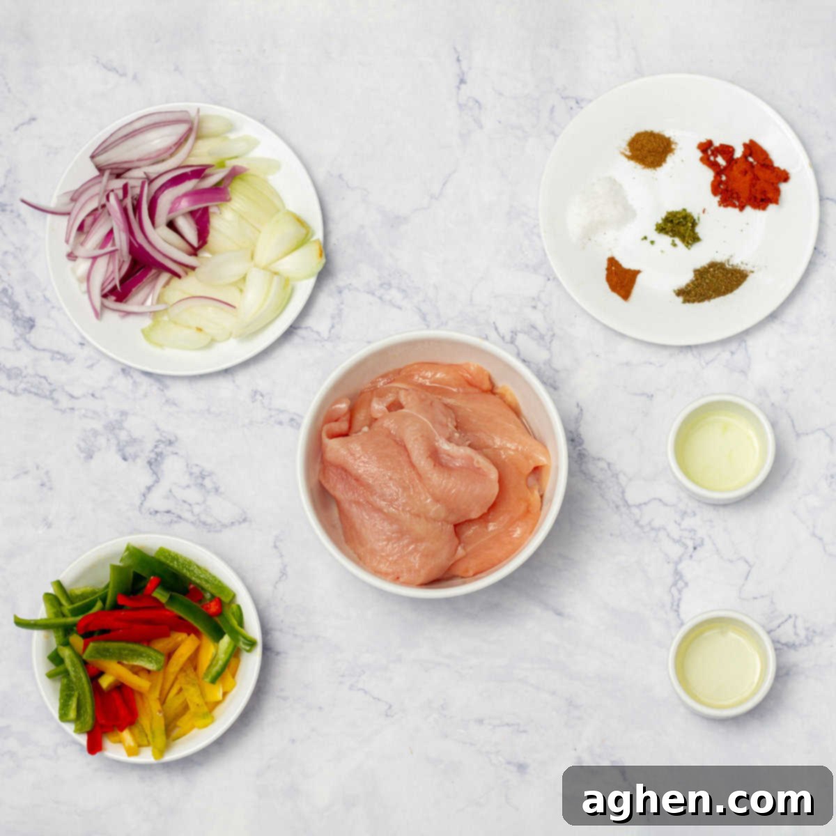 The Best Chicken Fajitas Zero Weight Watchers Points 3 Chicken fajita ingredients of raw chicken breast, onions, bell pepper strips, spices, and oil in separate dishes on a countertop.