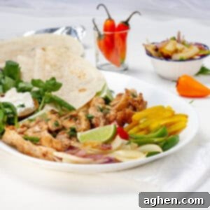 The Best Chicken Fajitas Zero Weight Watchers Points 7 Chicken fajitas with bell pepper and onion on a plate with tortillas.