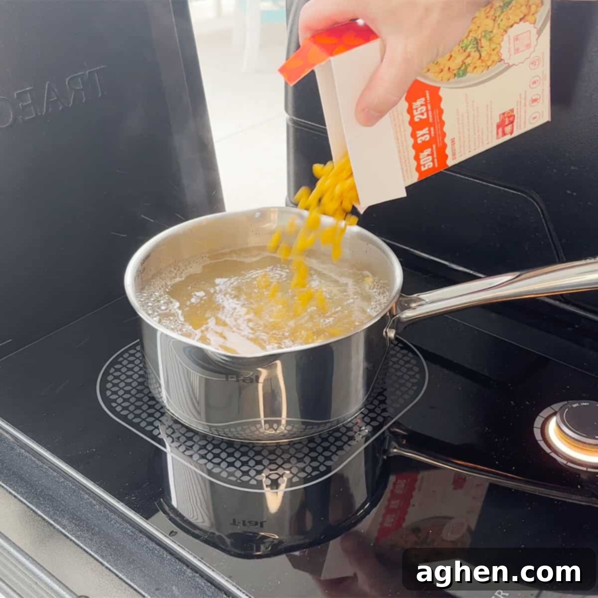 The Definitive Backyard Smoked Mac & Cheese 4 Boiling macaroni noodles in a pot.