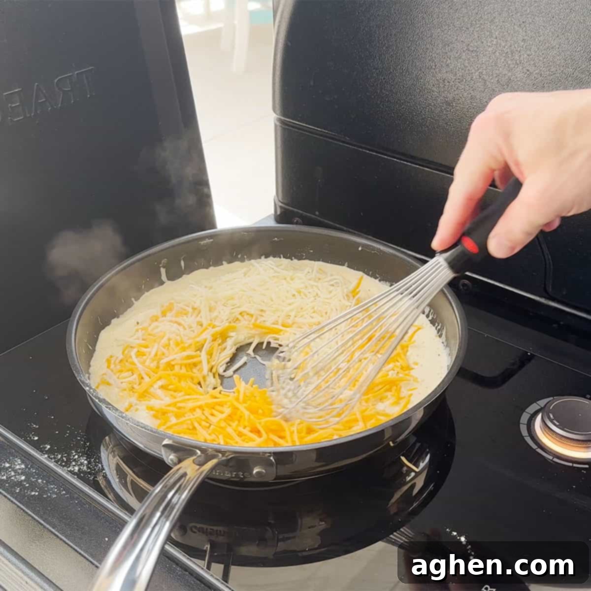 The Definitive Backyard Smoked Mac & Cheese 6 Melting cheese in a saucepan for mac and cheese.