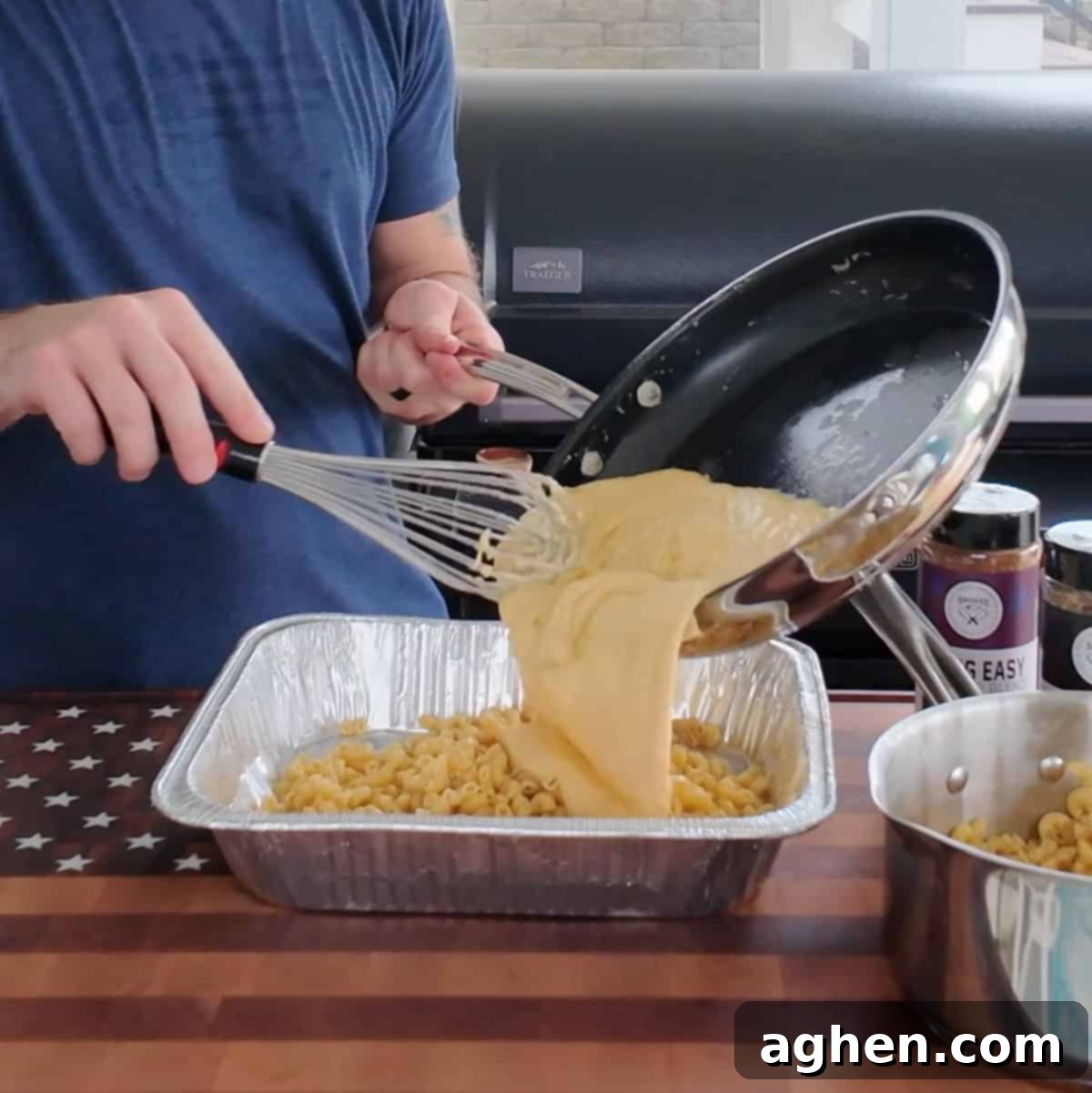 The Definitive Backyard Smoked Mac & Cheese 7 Macaroni noodles and cheese sauce being mixed in a pan.