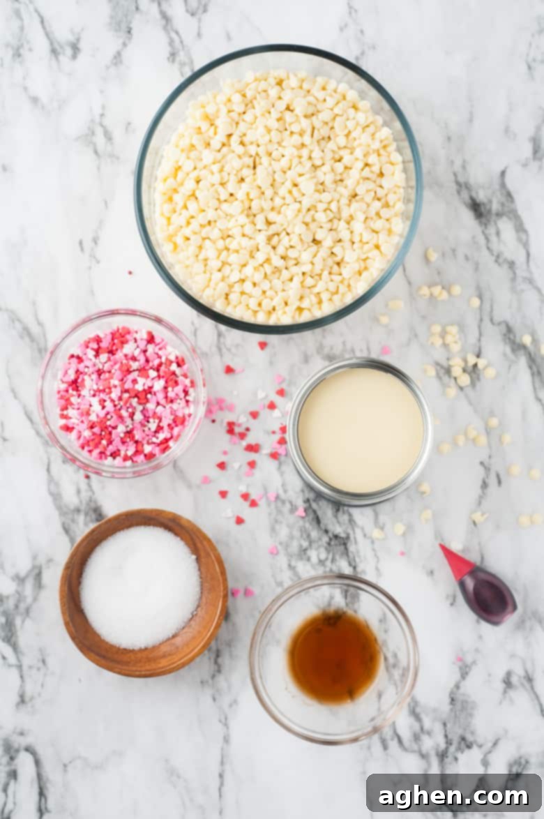 Valentine's Day Fudge Ingredients: white chocolate chips, heart sprinkles, can of sweetened condensed milk, vanilla extract, salt, and red food coloring, neatly laid out.