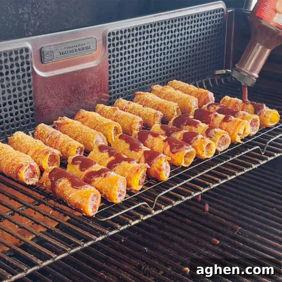 Smoked shotgun shells on the grill, glistening with a freshly basted layer of Bourbon BBQ sauce