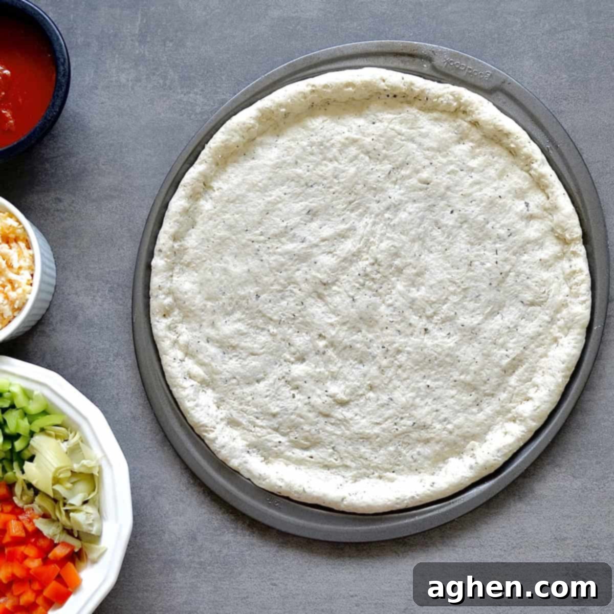 Homemade Weight Watchers Pizza: Why You'll Never Go Back to Store-Bought 5 Rolled out pizza dough on a pan, ready for par-baking.