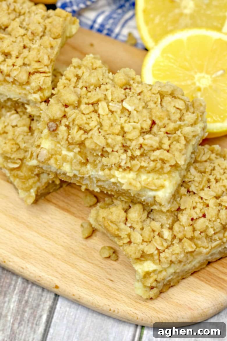 Close-up of a square Oatmeal Lemon Crumble Bar showing layers of crust and creamy filling