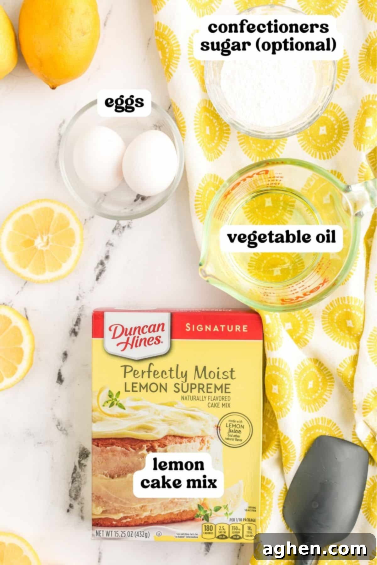 A box of lemon cake mix, two large eggs, a bowl of confectioners' sugar, and a bottle of vegetable oil, ready for baking.