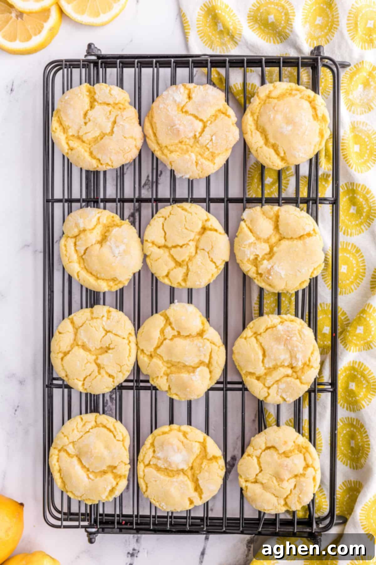 Freshly baked lemon cake mix cookies cooling on a wire rack.