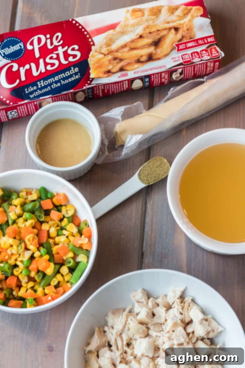 Ingredients for Easy Individual Chicken Pot Pies including pie crusts, broth, diced chicken, vegetables, and seasonings