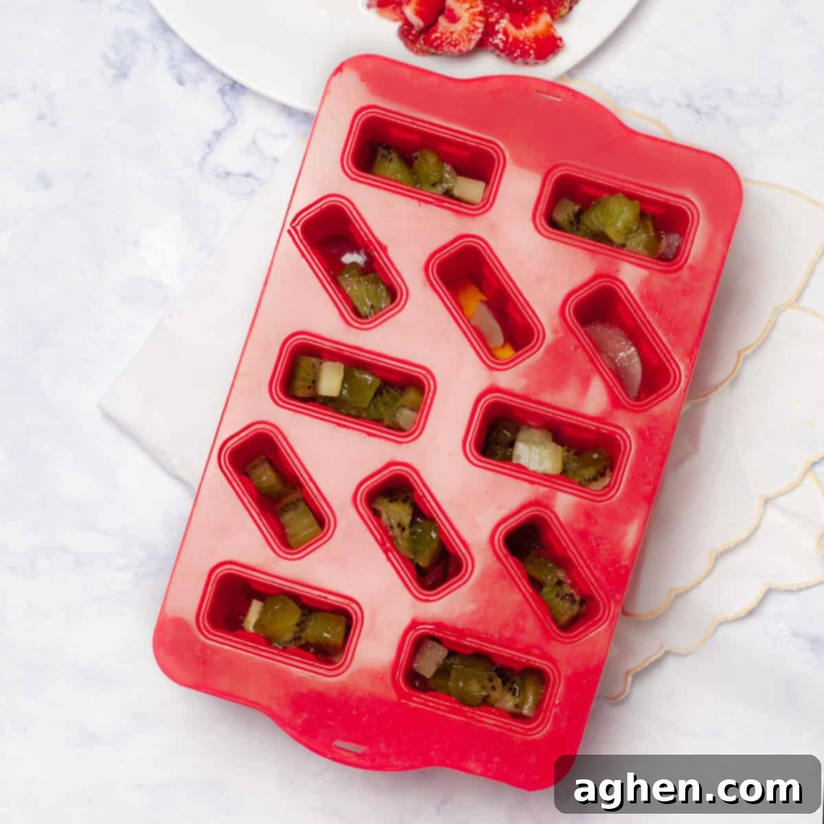 Your Family Will Crave These Healthy Yogurt & Fruit Ice Pops 5 Kiwis and mangos added to the chopped strawberry in popsicle molds.