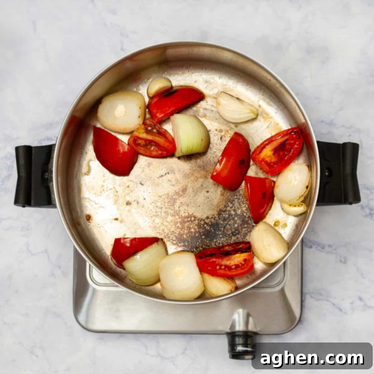 Aromatics sauteeing in a pan. 