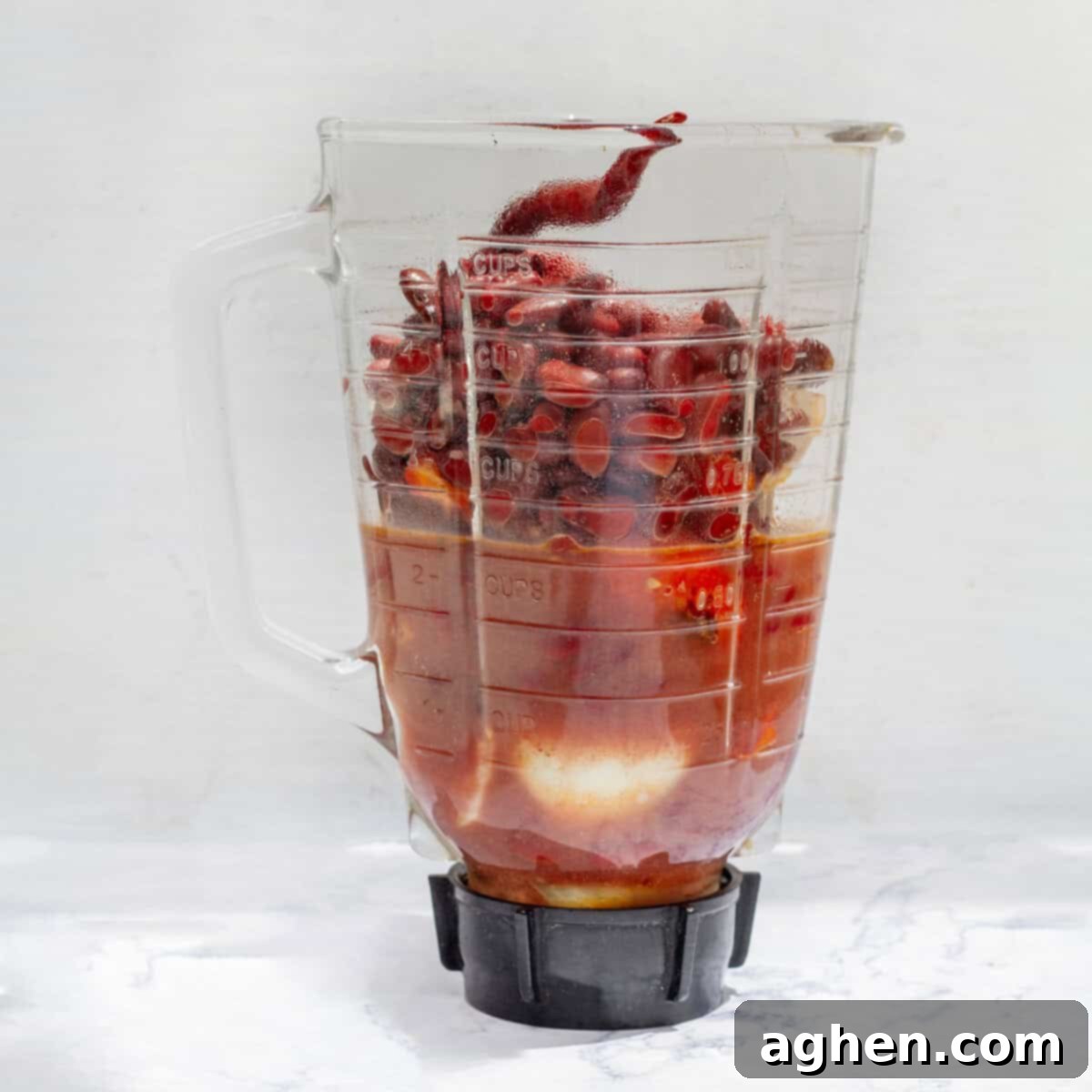 Cooked soup ingredients in a blender. 