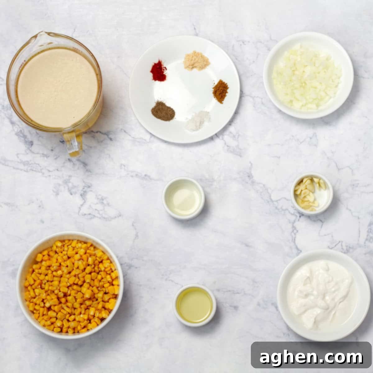 Comforting Mexican Street Corn Soup 3 All the essential ingredients for Mexican Creamy Corn Soup displayed in separate dishes on a kitchen counter, including corn, onions, garlic, spices, broth, and Greek yogurt.