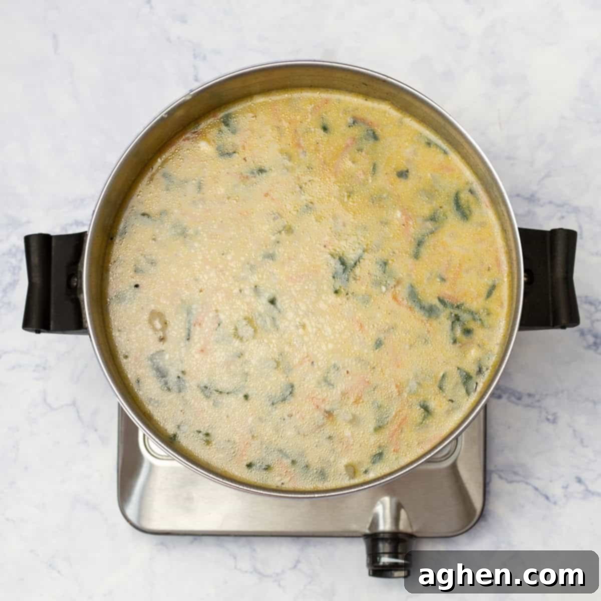 Finished, creamy, and thickened chicken and gnocchi soup in a pot, ready to be served.