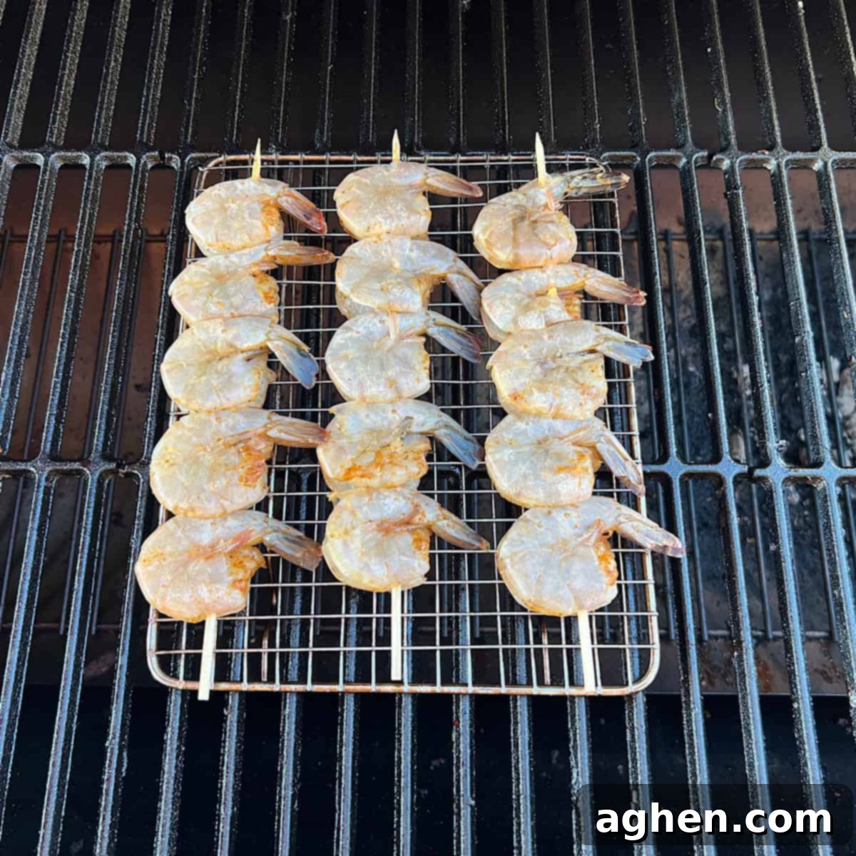 Smoked Shrimp: Effortlessly Delicious 6 Raw shrimp on a grill grate inside an offset smoker