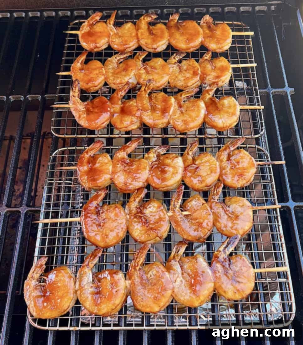 Smoked Shrimp: Effortlessly Delicious 7 Perfectly smoked shrimp on a grill grate, ready to be removed