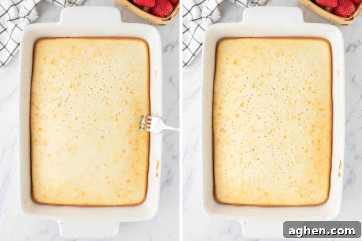 Rectangular white cake with holes being poked all over the top with a large fork.