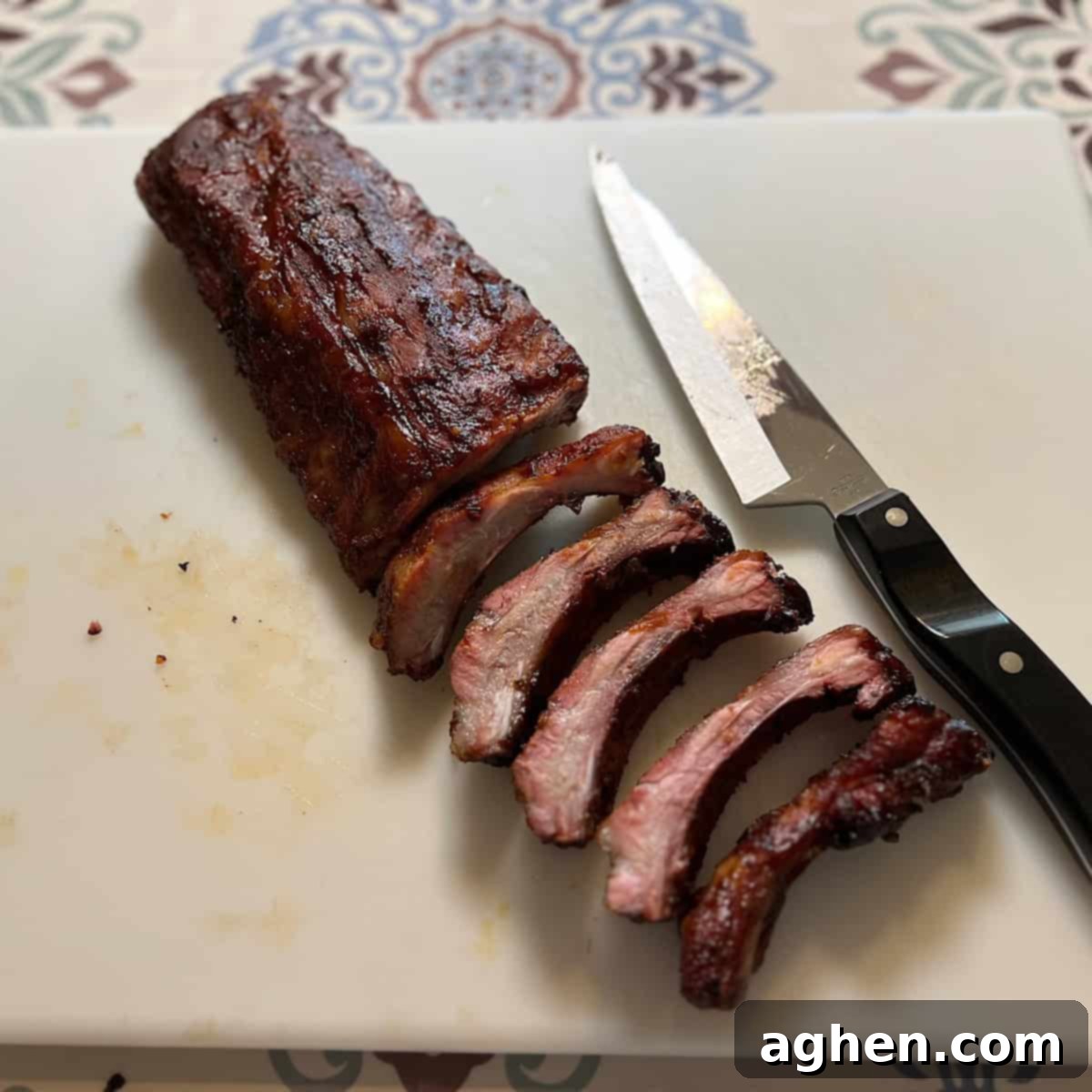 6 Blunders That Will Destroy Your Smoked Baby Back Ribs 13 Smoked baby back ribs resting on a cutting board, tented with foil.