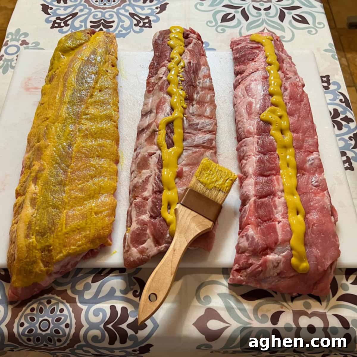 6 Blunders That Will Destroy Your Smoked Baby Back Ribs 5 Baby back ribs coated in yellow mustard, ready for dry rub.