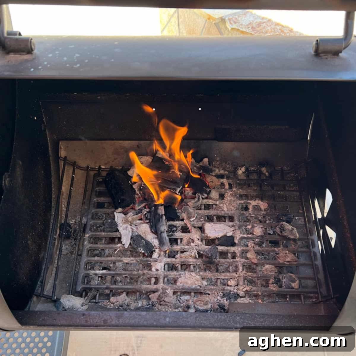 6 Blunders That Will Destroy Your Smoked Baby Back Ribs 10 Close-up of wood chunks smoldering in a smoker firebox.