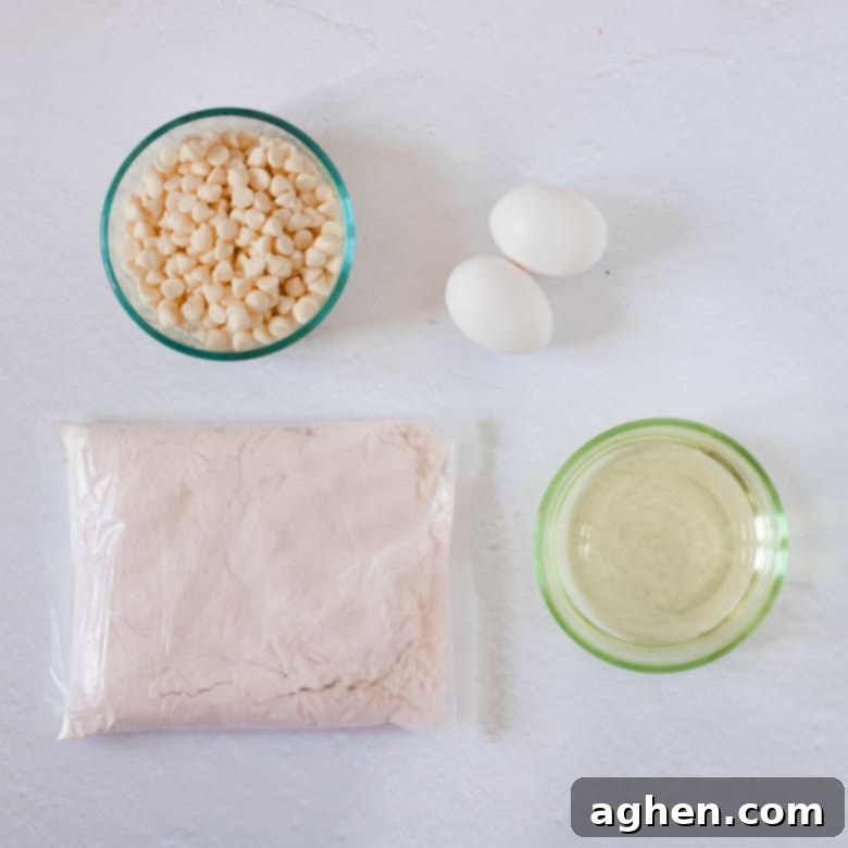 Simple Strawberry Cake Mix Cookies 3 Ingredients for strawberry cake mix cookies: white chocolate chips, vegetable oil, 2 eggs, and a box of strawberry cake mix.