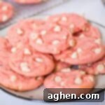 Simple Strawberry Cake Mix Cookies 7 Strawberry cake mix cookies with white chocolate chips on a white plate.