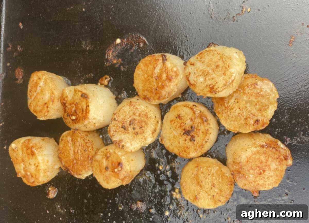 Perfectly seared grilled scallops on a Weber grill.