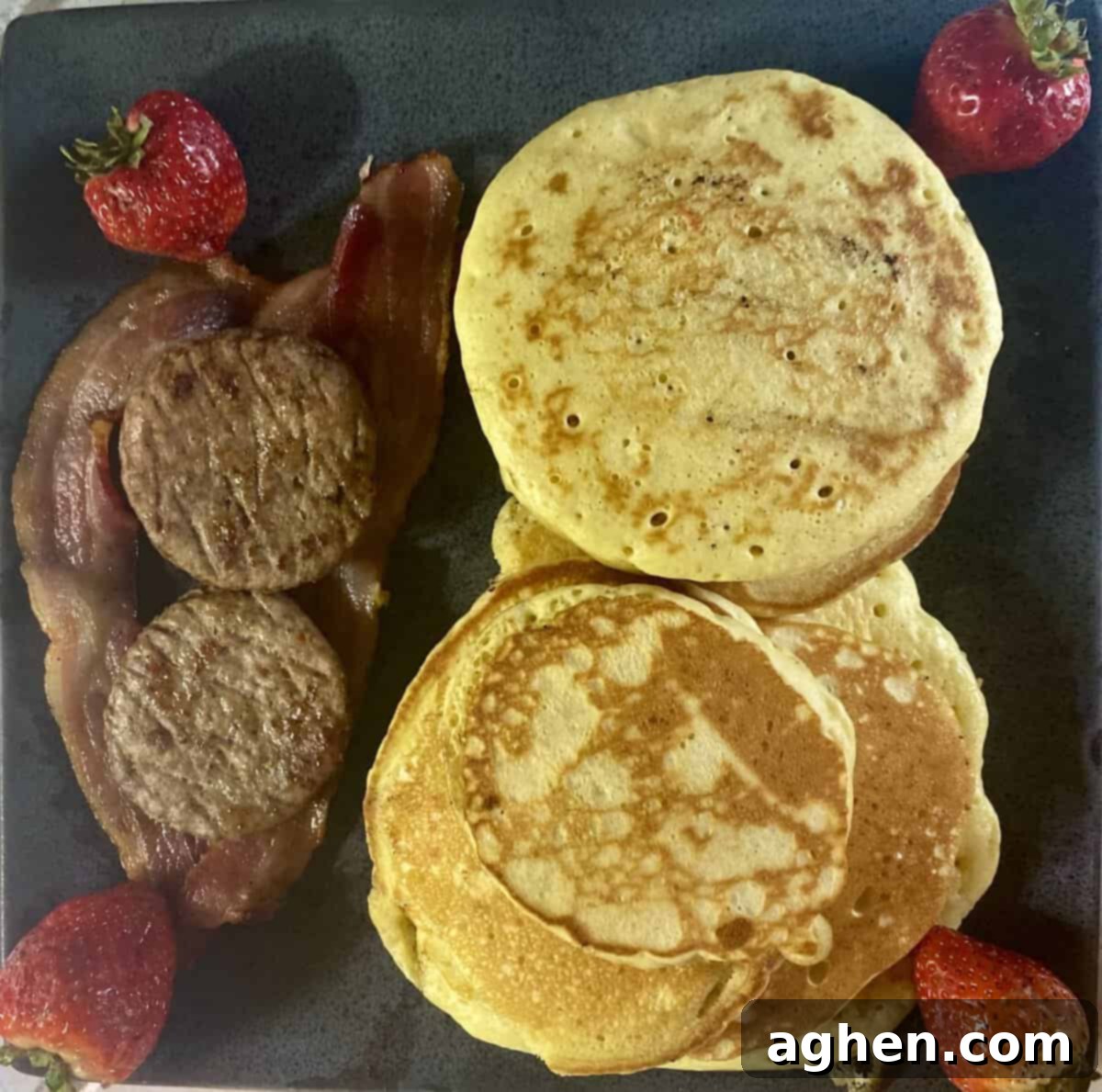 The Weber Griddle: Effortless Breakfast Grilling Starts Now 5 Strips of crispy bacon and sausage links cooking on a hot griddle surface.