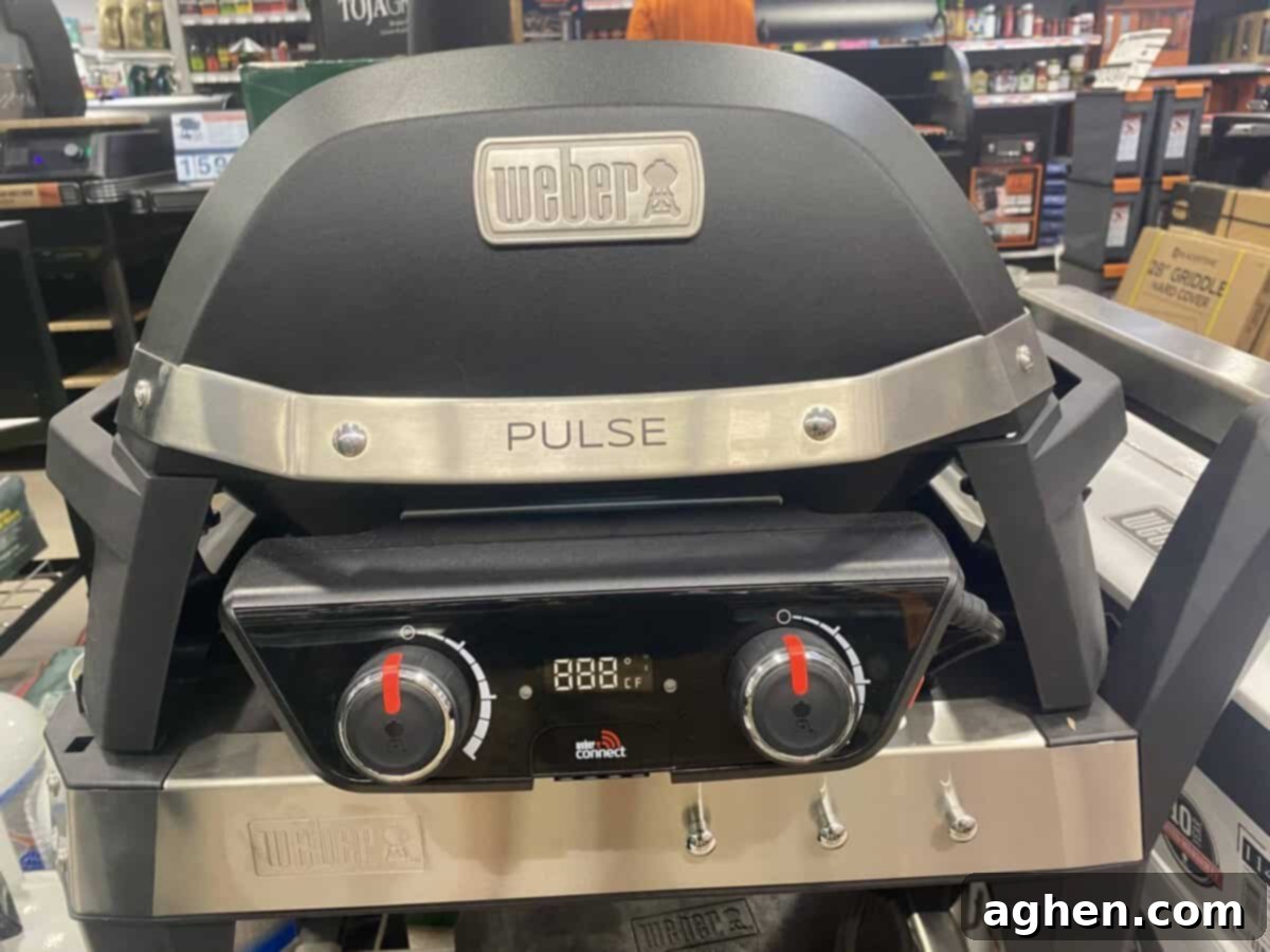 Weber Lumin Electric Grill in a modern outdoor patio, showcasing its sleek design.