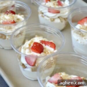 Weight Watchers' Legendary Cheesecake Fluff 8 Cheesecake cups with fresh strawberries and graham cracker topping.