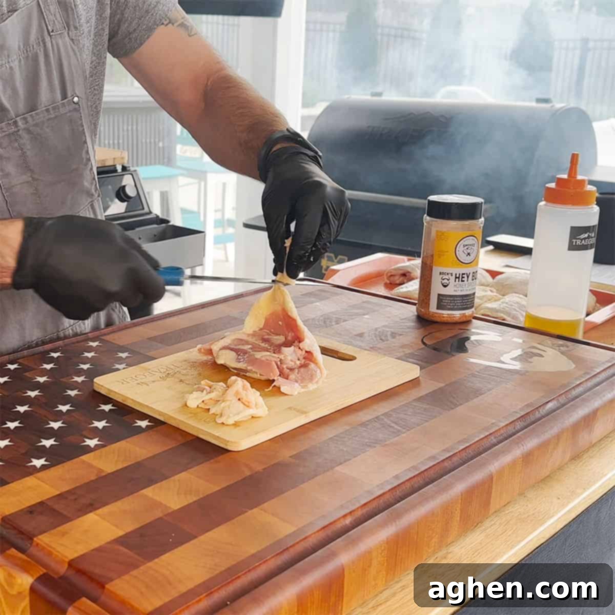 Raw chicken thighs being prepared with olive oil as a binder for seasoning.