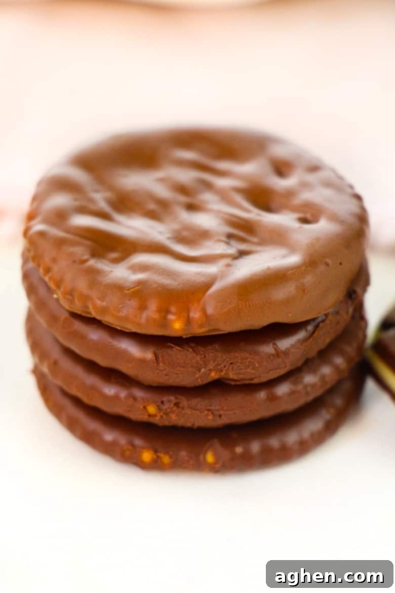 Ritz Cracker Thin Mints - Finished chocolate-covered Ritz crackers on parchment paper, ready to be enjoyed