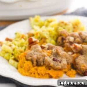 Pecan Streusel Sweet Potato Casserole on white plate with stuffing