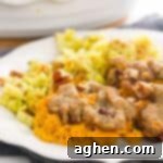 Pecan Streusel Sweet Potato Casserole on white plate with stuffing