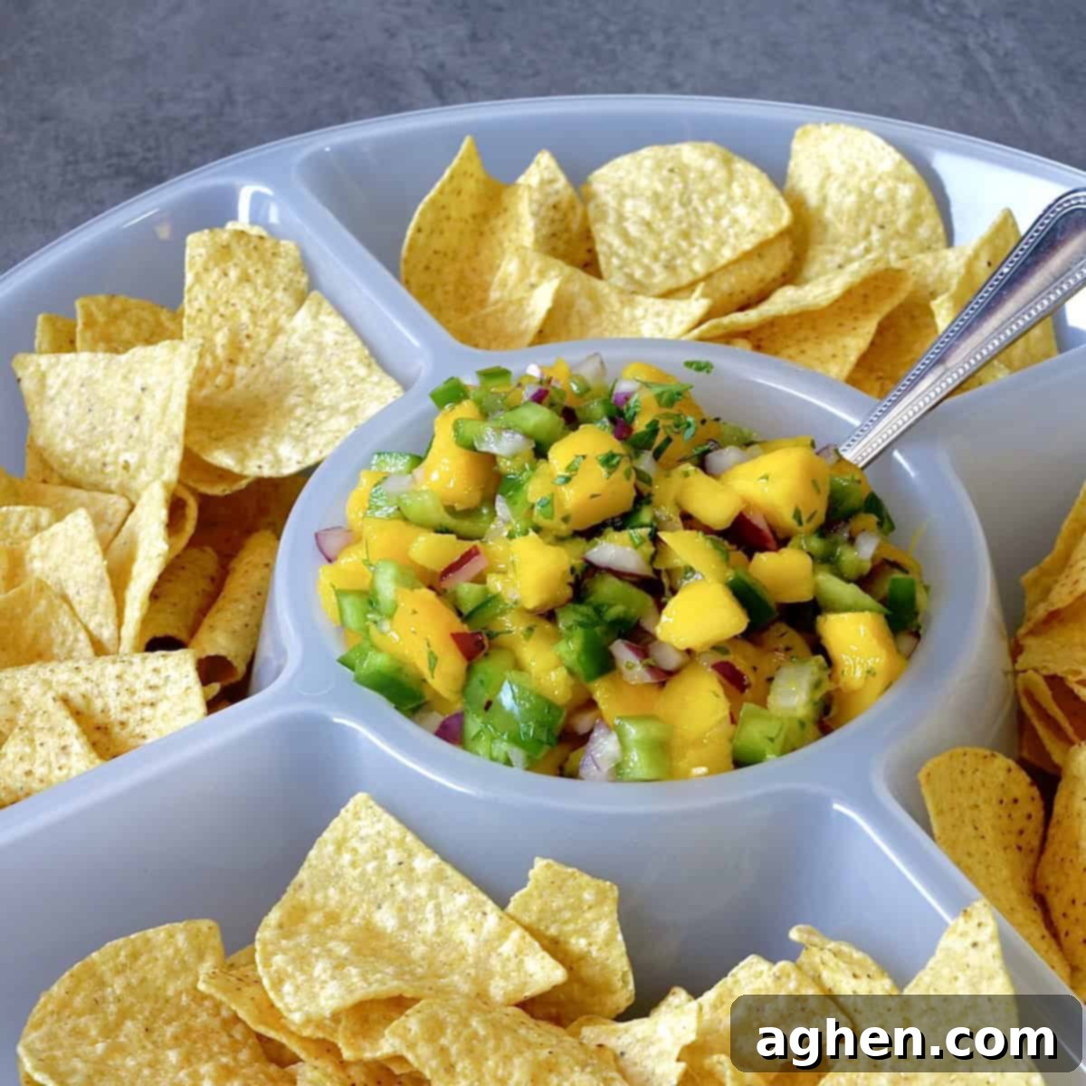 Mango salsa in a chip and dip platter, showcasing vibrant colors