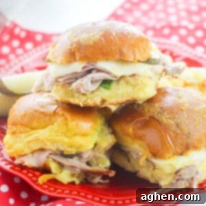 Cuban Slider sandwiches with pork, ham, swiss, pickles, and mustard on hawaiian rolls.