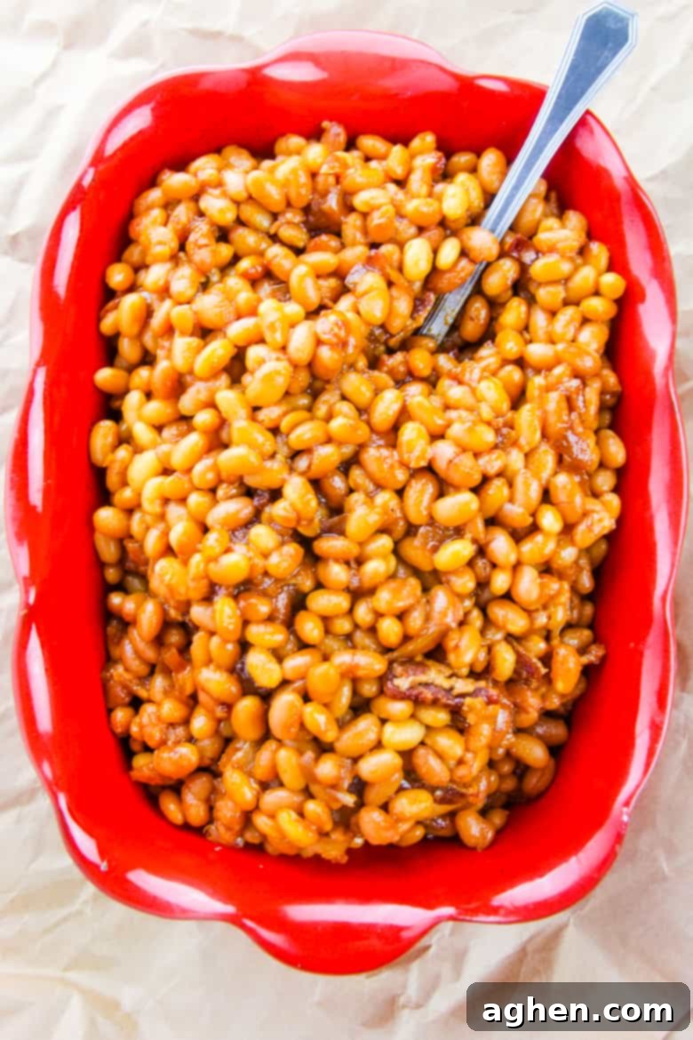 Overhead image of rectangular red dish with boston baked beans.