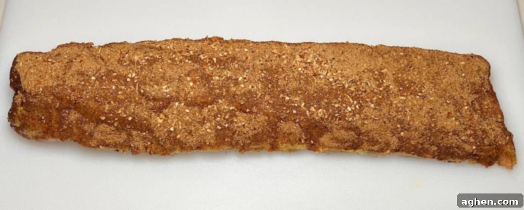 Rib rub generously applied to baby back ribs