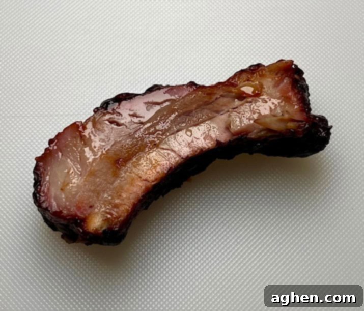 Single perfect baby back rib showing tenderness