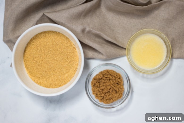 Ingredients for a graham cracker crust: graham cracker crumbs, melted butter, and brown sugar in separate bowls.