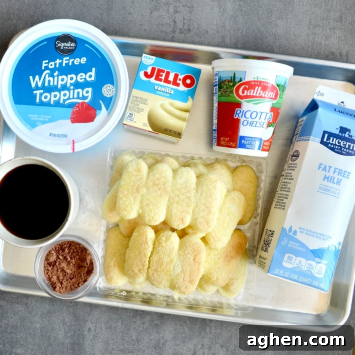 My New Obsession: The Weight Watchers Tiramisu I've Made 3 Weeks Running 3 Various ingredients laid out for making Weight Watchers tiramisu, including milk, pudding mix, cool whip, ricotta, ladyfingers, and cocoa