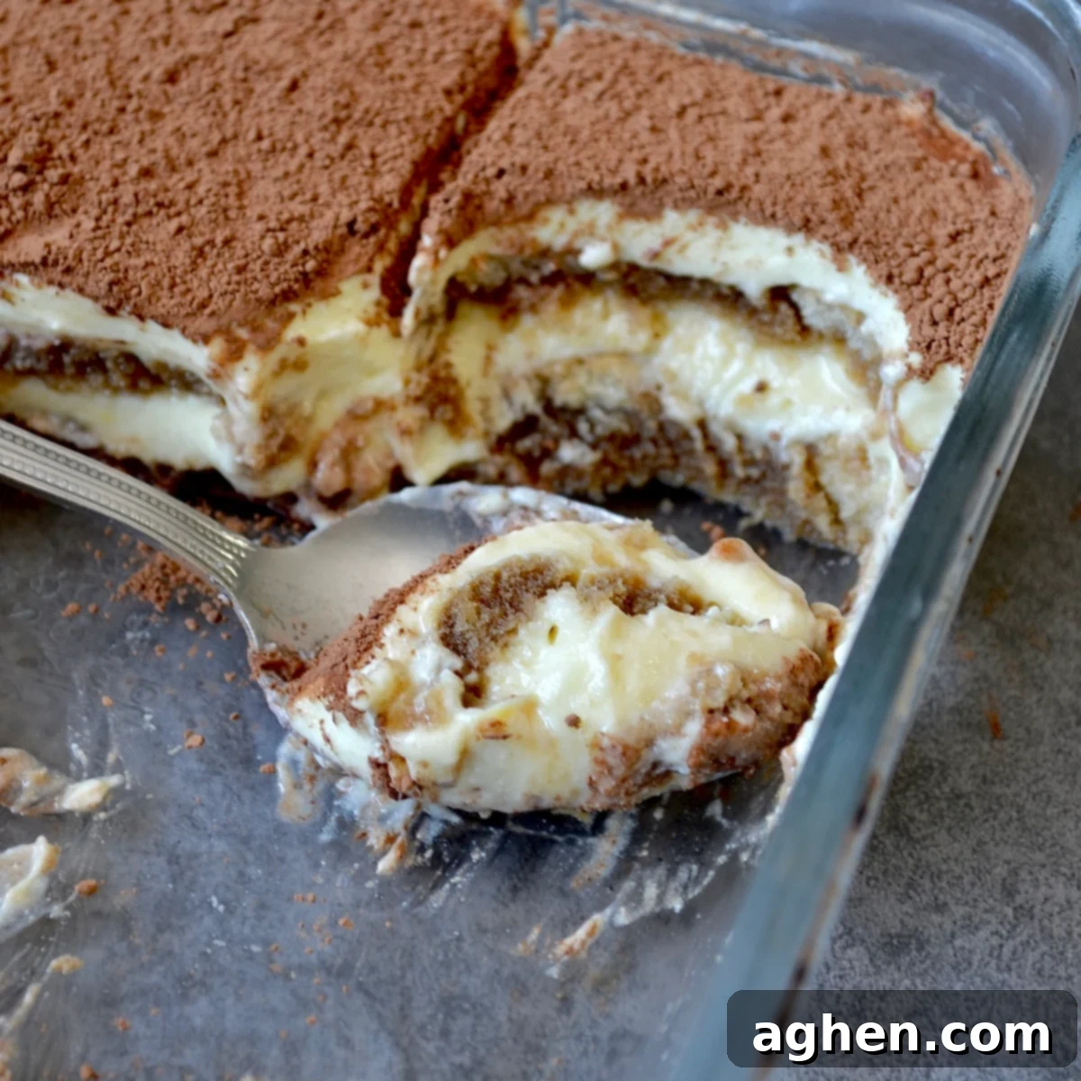 My New Obsession: The Weight Watchers Tiramisu I've Made 3 Weeks Running 8 Spoon scooping a serving of tiramisu from the dish, showing its creamy layers