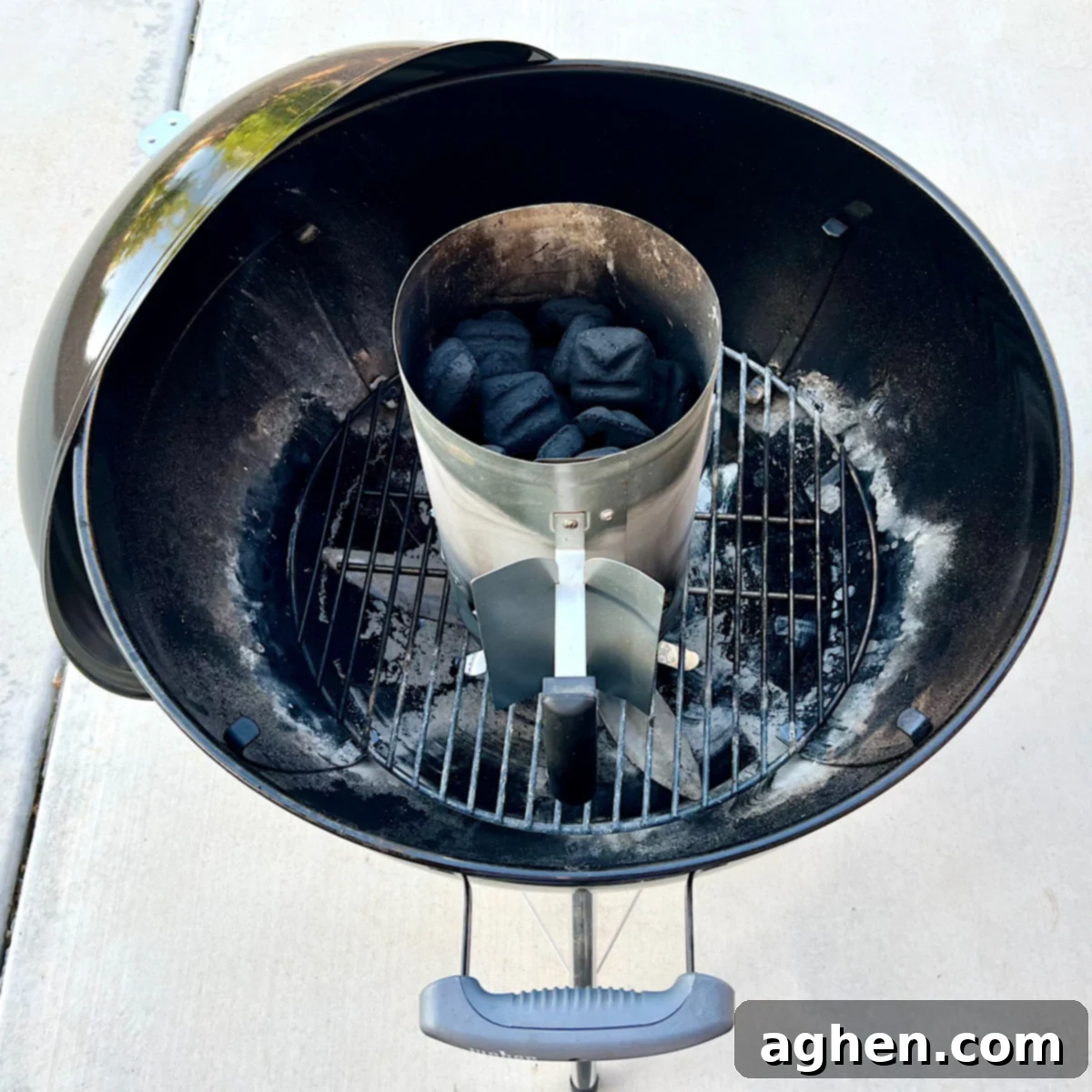 Master The Perfect Grilled Porterhouse Steak 5 Charcoal chimney fire starter on a charcoal grate, full of lit briquettes