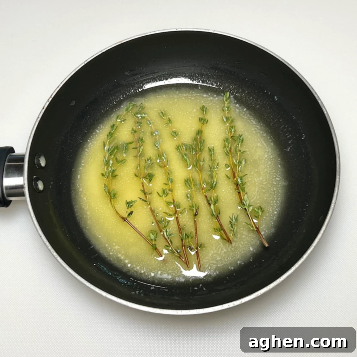 Master The Perfect Grilled Porterhouse Steak 8 Melted butter with fresh thyme sprigs infusing in a sauté pan