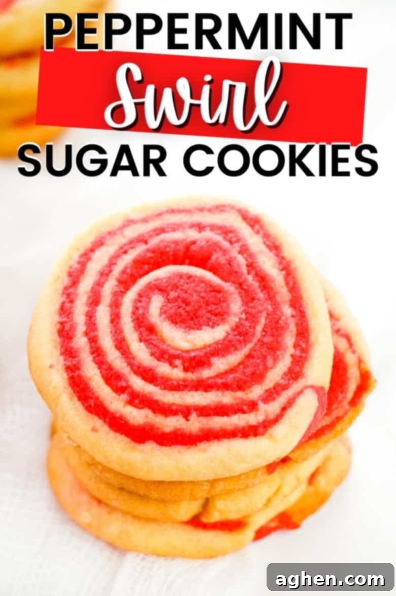 Peppermint Swirl Sugar Cookies - A tall stack of beautiful red and white peppermint pinwheel cookies.