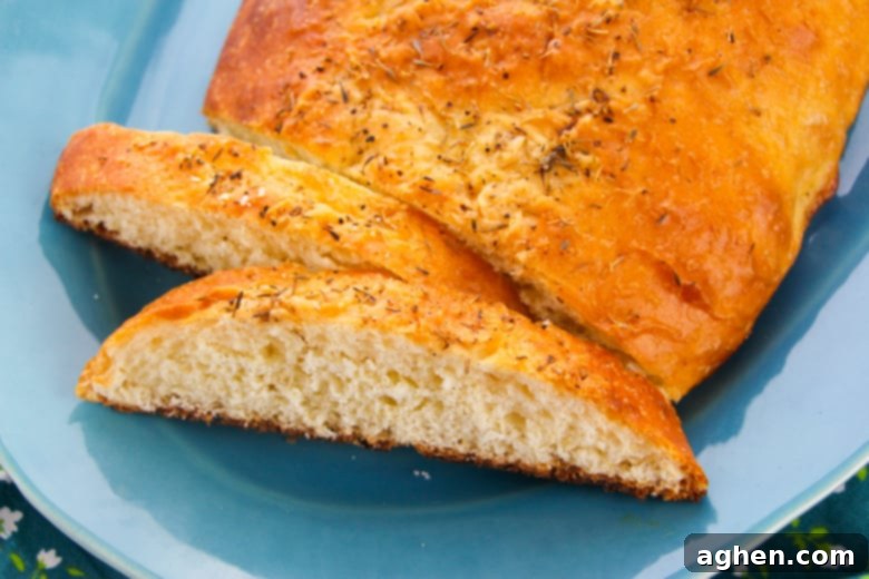 Sliced crusty bread topped with Italian Seasonings