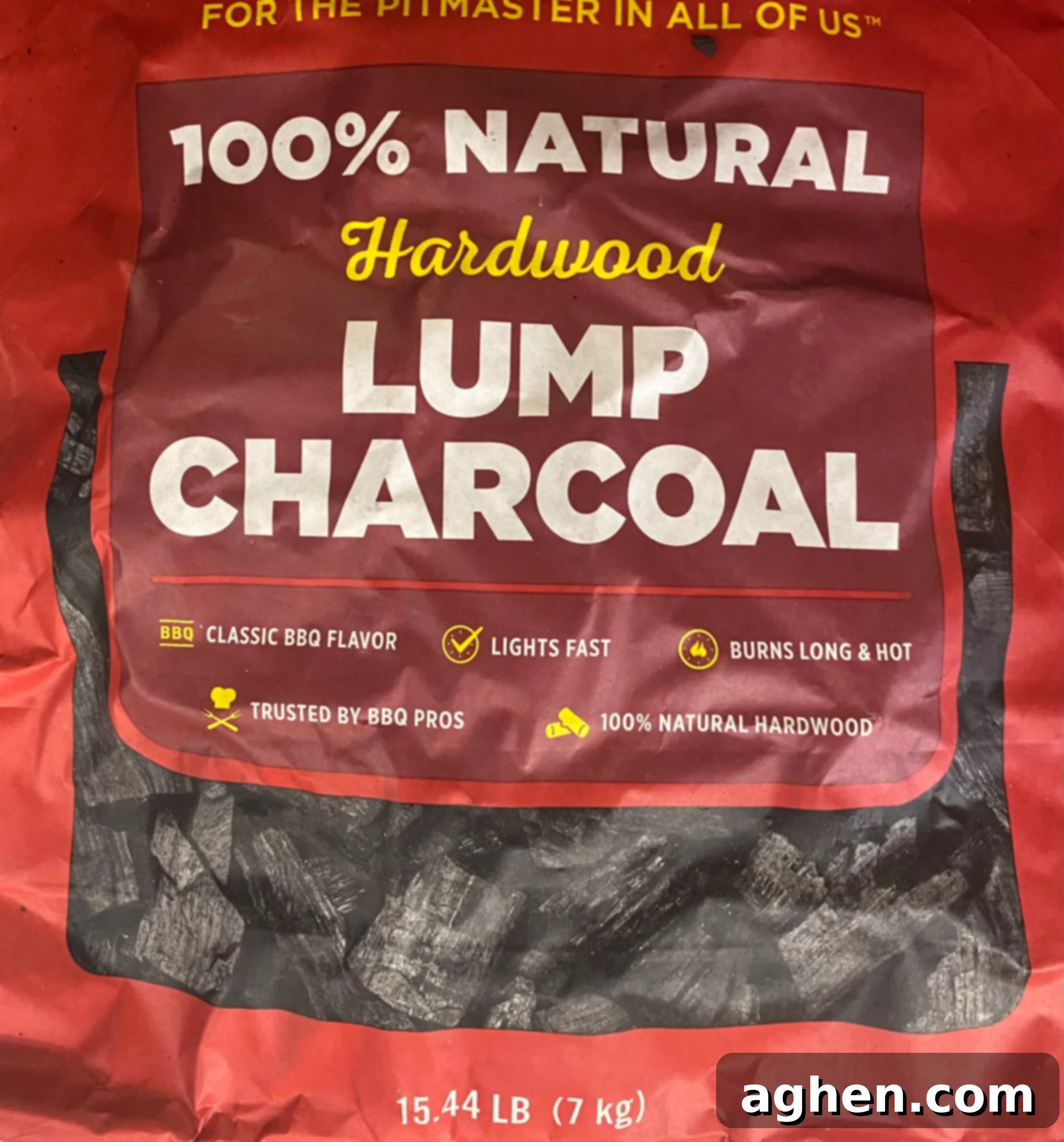 Wood chips smoking on charcoal in a Weber grill for enhanced flavor.